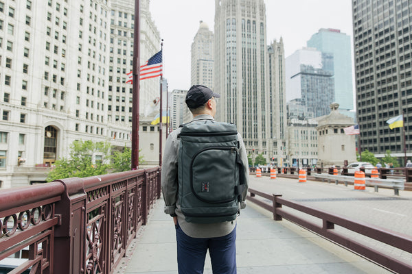 Person wearing the Aeronaut 30 as a backpack on a walkway.